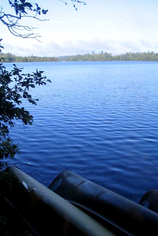 A morning view of Knife Lake over canoes